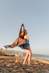 Woman running and holding scarf on wave relax and happy on beach
