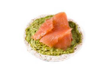 Puffed rice cake with guacamole and salmon isolated on white background. 	