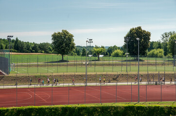 children on scooters in front of the school playing field