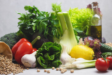The concept of a healthy diet, products for a healthy balanced diet. Lentils, green vegetables, olive oil, paprika, fennel, lettuce, lemon, onions and broccoli