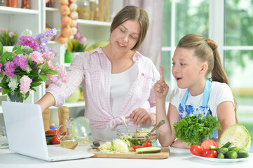 Portrait of funny girls preparing fresh salad