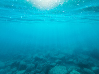 the sun's rays fall from above, penetrating seawater to the bottom