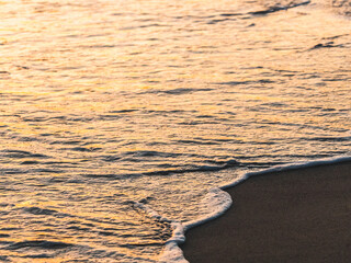 Close up abstract of ocean waves  coming in to shore at sunrise
