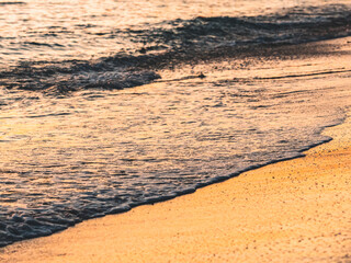 Close up abstract of ocean waves  coming in to shore at sunrise