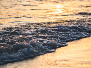 Close up abstract of ocean waves  coming in to shore at sunrise