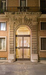 Rome Italy, vintage building entrance arched door, night view
