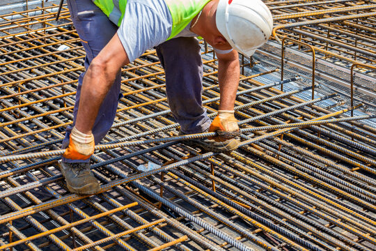 Construction worker installing rebar