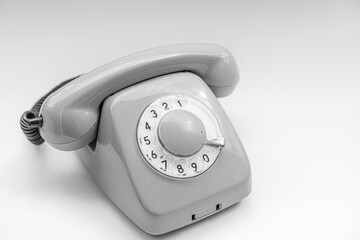 Old disk telephone on a white background
