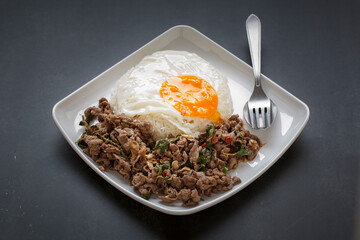 streamed rice topped with basil stir fried beef and fried egg
