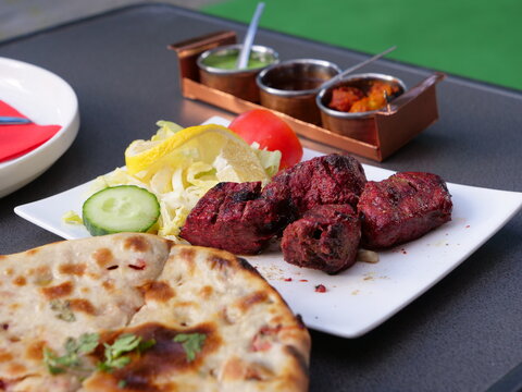 Some Food At A Indian Restaurant On A Table Outside