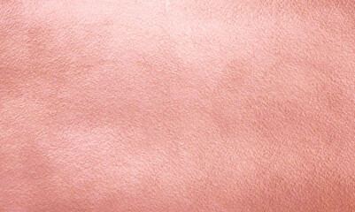 Pink gold metal texture. Rough textured golden rose metallic background. Luxury brilliant gold foil, paper. Vintage shiny design template for lettering, text, cards, banners.