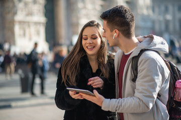 Tourists using a digital tablet in a city