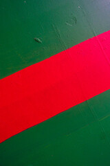a red and green stripe on a metal pole