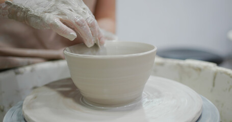 Potter making ceramic pot on the pottery wheel