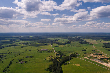 Fototapeta na wymiar Aerial view. Countryside surrounded by green fields. Small town.