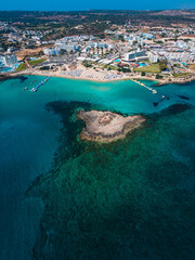 Fototapeta na wymiar Amazing aerial view over one of the best beaches in Protaras, Cyprus. Yellow sand, blue and turquoise water - perfect summer getaway, luxury vacation in Mediterranean 