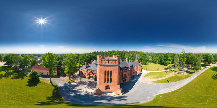 An aerial drone view of the Sangaste Castle, Estonia. Old red brick manor house in the style of English castles. Good place for a big wedding. 360 degrees panorama