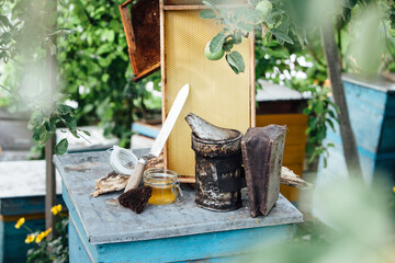 A tool of the beekeeper. Everything for a beekeeper to work with bees. Smoker, a chisel, a box,...