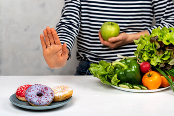 woman refuse junk food but healthy food choice. Diet concept.