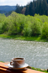 Cup of coffee on a wooden terrace