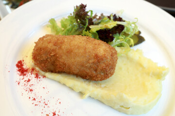 Chicken Kiev with mashed potatoes on plate