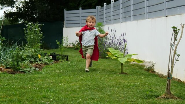 Happy little child playing superhero