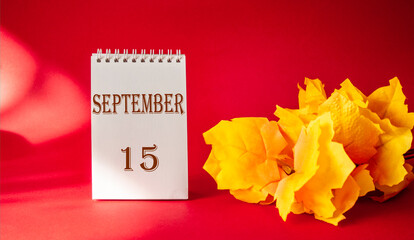 Calendar with the text October 15 on a red background and with a maple leaf