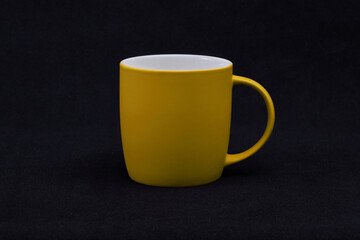yellow cup on black background 