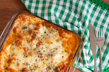 Traditional italian lasagna with cheese. On a wooden background.