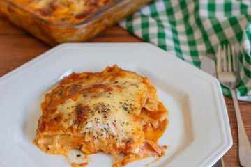 Traditional italian lasagna with cheese. On a wooden background.