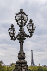 Art Nouveau lamps on famous Alexandre III Bridge in Paris. Alexandre III Bridge, with exuberant, cherubs, nymphs and winged horses at either end, was built in 1896 - 1900. Paris, France.
