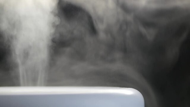 White steam of ultrasonic humidifier. Frume of vapor from diffuser for air moisturize. Loop endless video of smoke for humidity at home. Moisturizer and purifier of air. Diffused mist from inhaler.