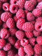Delicious ripe raspberries on the table macro