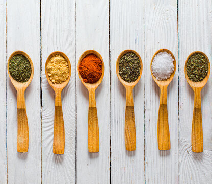 Set of measure spoons with spices, isolated on white