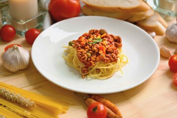 Delicious  Spaghetti Bolognese served on white plate for romantic dinner with  ingredient background.