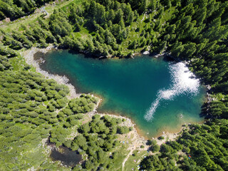 Fototapeta na wymiar Aerial view of a blue mountain lake with forests