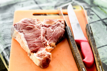 Raw Florentine beef steak on a cutting board