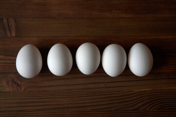 Eggs on a wooden table. View from above.