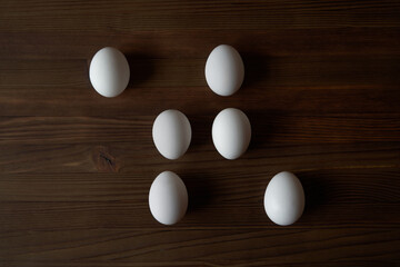 Eggs on a wooden table. View from above.