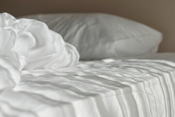 Fototapeta na wymiar White mattress in the morning with the light lay on the bed.