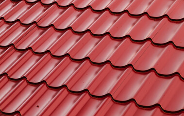 Red metal shingles roof slope, background photo