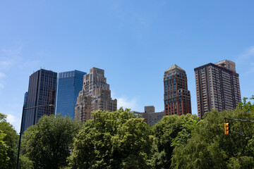 Fototapeta na wymiar Lincoln Square New York Skyline seen from Central Park with Green Trees