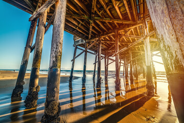 Newport Beach wooden pier seen from the ground at sunset