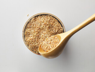 Top view shot of brown rice on white background.