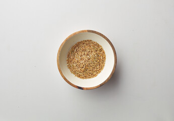 Top view shot of brown rice on white background.