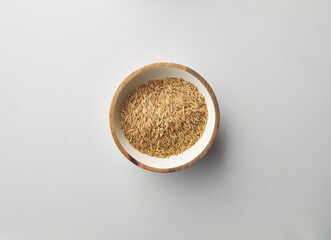 Top view shot of brown rice on white background.