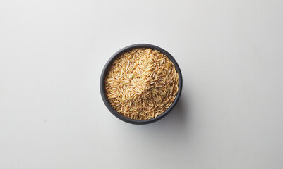 Top view shot of brown rice on white background.