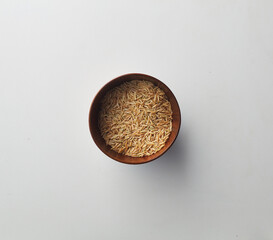 Top view shot of brown rice on white background.