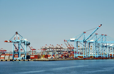Fototapeta na wymiar Newark, NJ / USA - View of the container terminal with gantry cranes and stored containers. 