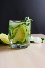 Refreshing mint cocktail mojito with rum and lime, cold drink or beverage with ice on black...